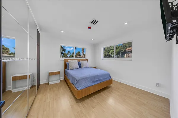 a bedroom with a bed and a painting on the wall