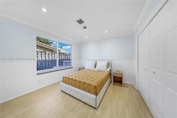 a bedroom with a bed and a large window