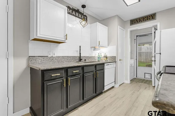 a kitchen with stainless steel appliances granite countertop a sink stove and cabinets