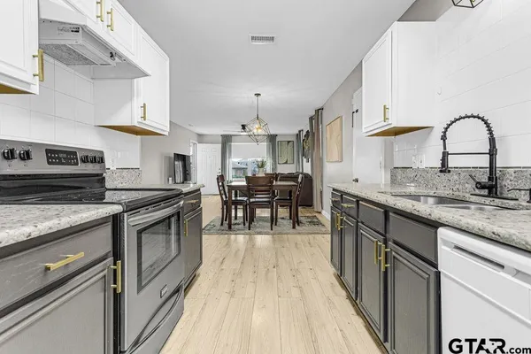 a kitchen with stainless steel appliances granite countertop a stove and a sink