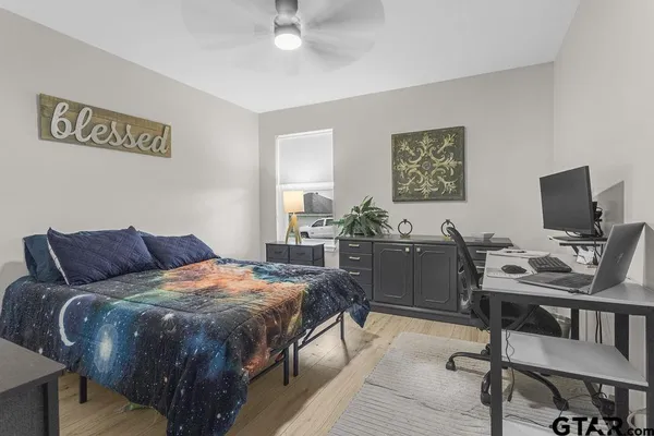a bedroom with a bed and a desk