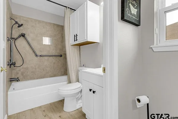 a bathroom with a toilet and a bath tub