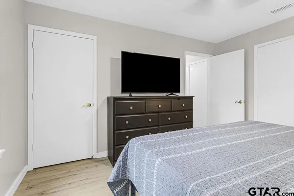 a bedroom with a bed and a flat screen tv