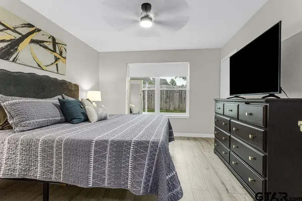 a bedroom with a bed and flat screen tv