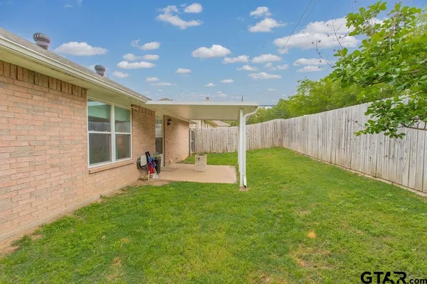 a view of backyard with a garden and deck
