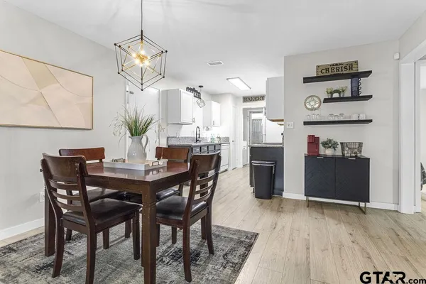 a view of a dining room with furniture and wooden floor