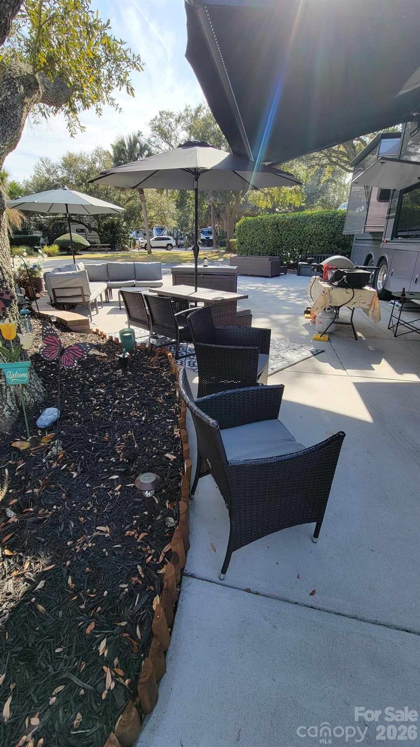 43B Jenkins Island Road, Unit 177 Hilton Head Island, SC 29926 - Photo 10 of 18 a building outdoor space with patio furniture and potted plants