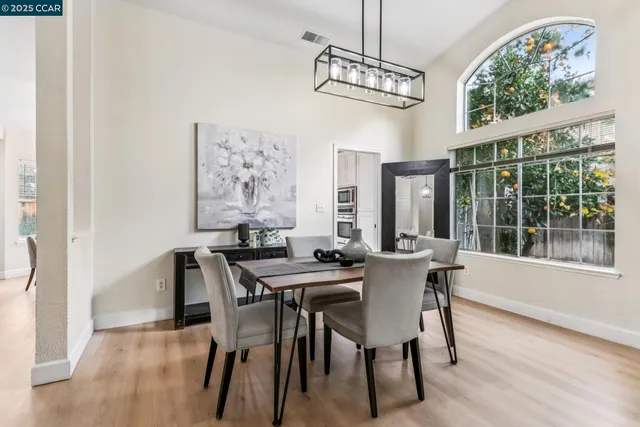a view of a dining room with furniture large windows and wooden floor