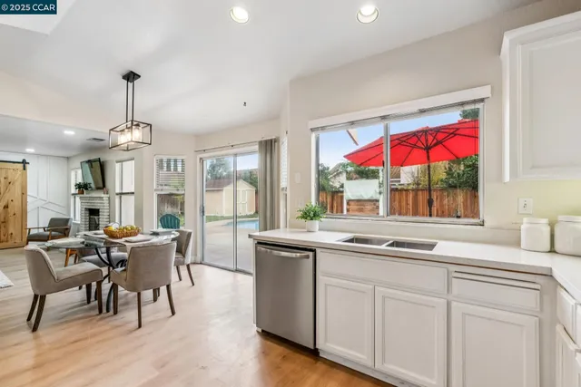 a kitchen with a sink cabinets stainless steel appliances and a window