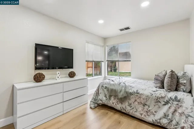 a bedroom with a bed a desk and chair