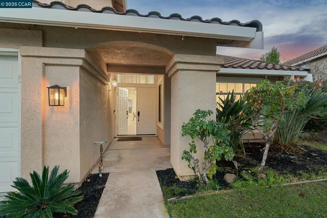 a front view of a house with garden