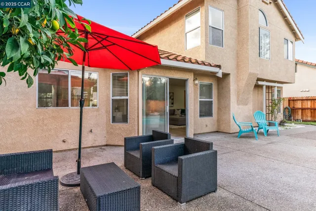 a front view of a house with porch and sitting area