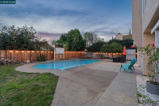 a view of a swimming pool with an outdoor space and seating area