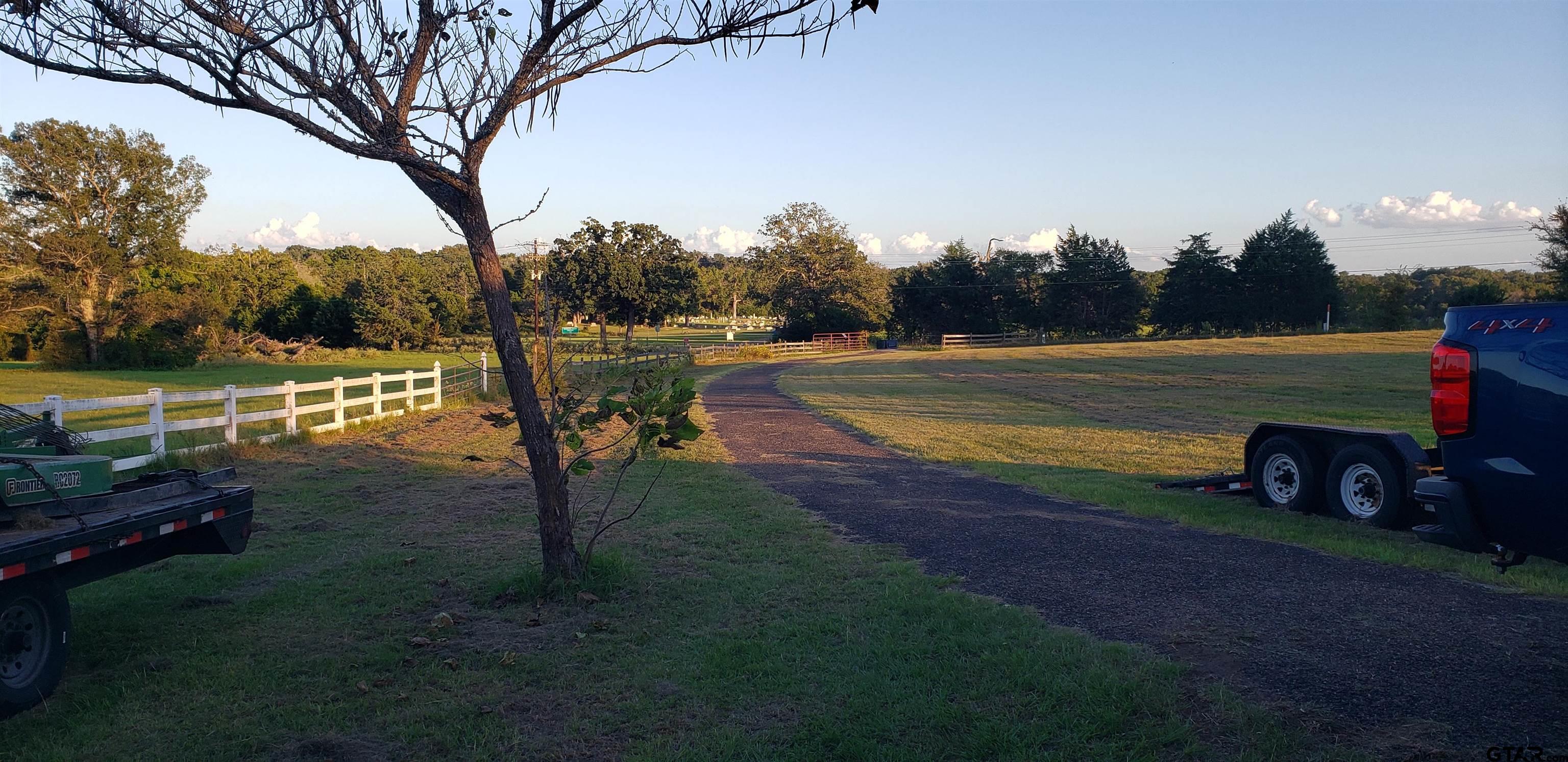 a view of a lake with large trees