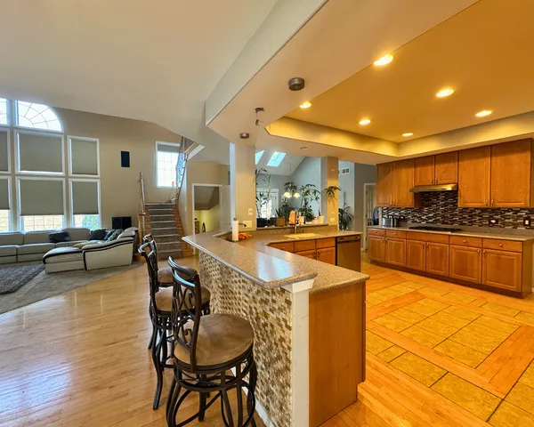 a view of a living room and kitchen with a dining table