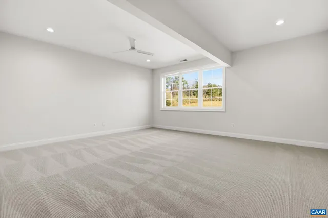 a view of an empty room with a ceiling fan