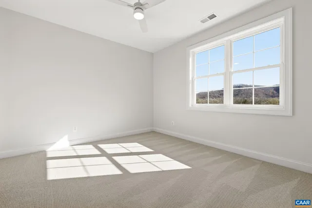 a view of house with yard and sitting area