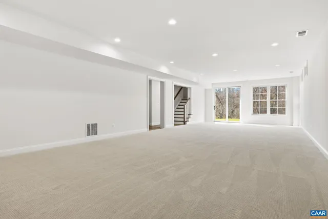 a living room with furniture tv and a large window