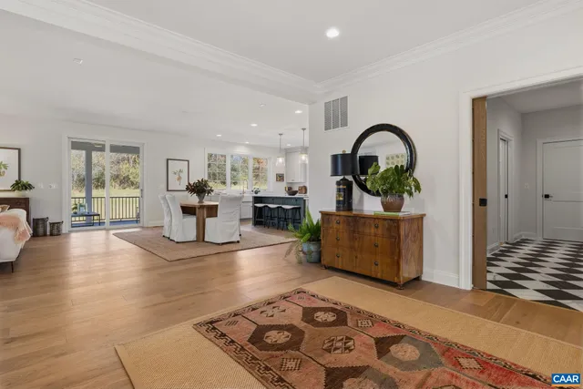 a living room with furniture fireplace and a large window