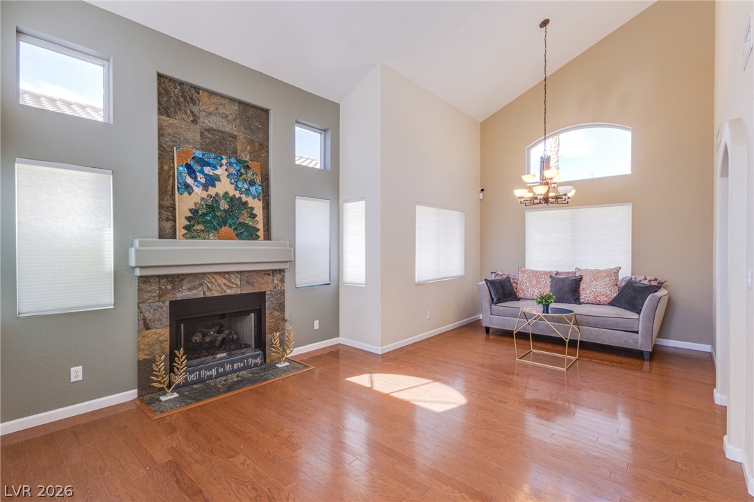 253 Camelback Ridge Avenue Henderson, NV 89012 - Photo 15 of 26 Soaring vaulted ceilings and polished hardwood flooring elevate this spacious living area with a stone fireplace.