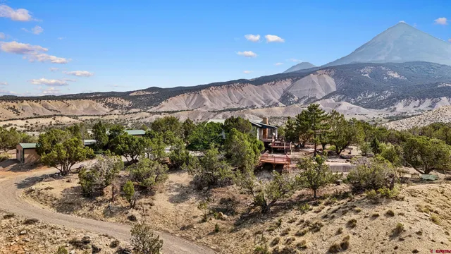 a view of a patio with table and chairs and potted plants