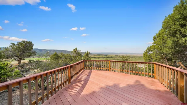 a view of balcony with wooden floor and fence