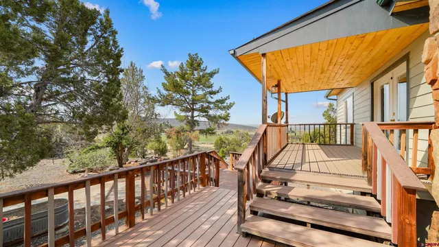a view of a house with backyard porch and sitting area