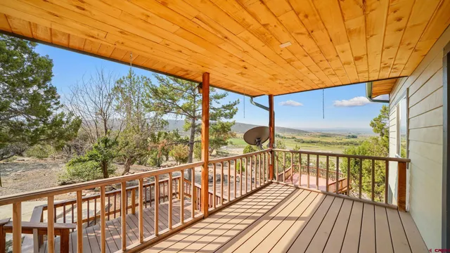 a view of a balcony with wooden floor