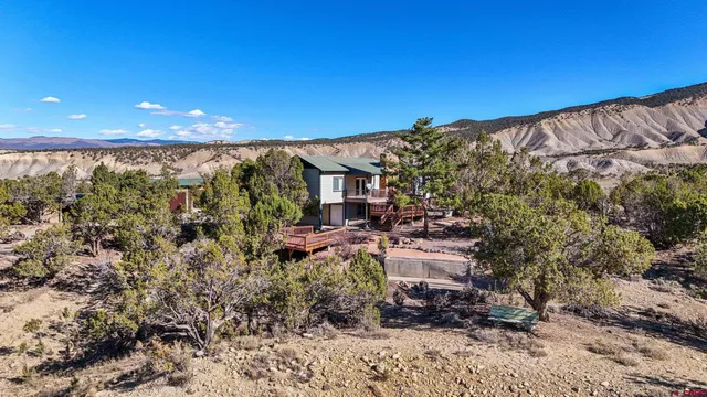a view of a backyard with wooden fence