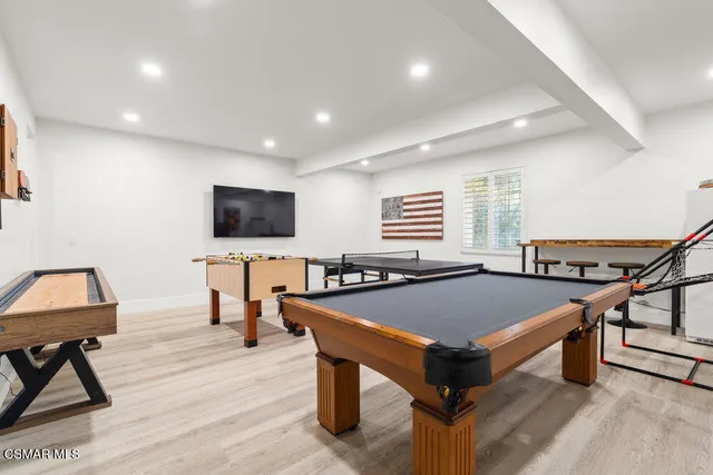 a room with table chairs and flat screen tv