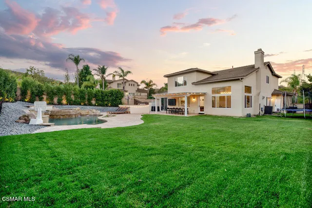 a view of a house with a backyard