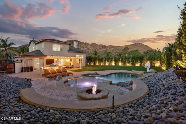 an aerial view of a house with garden space and swimming pool