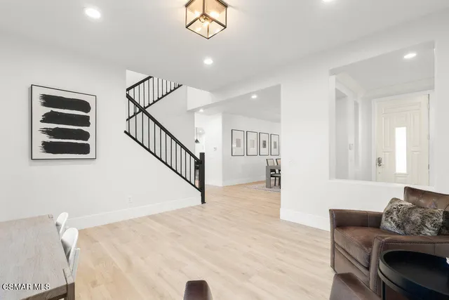 a living room with furniture and stairs