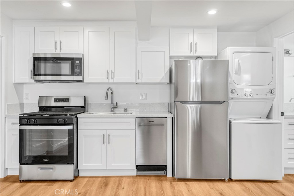 221 Sheldon Street El Segundo, CA 90245 - Photo 5 of 34 a kitchen with stainless steel appliances granite countertop a refrigerator stove a sink and a oven with white cabinets