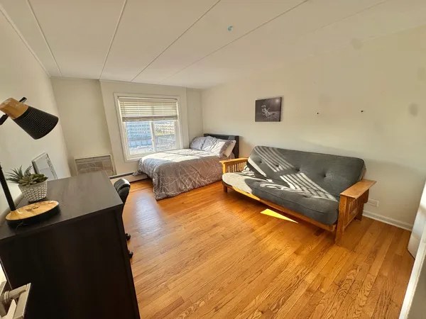 a living room with a bed and furniture