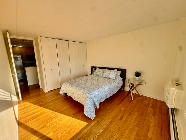 a bed sitting in a bedroom next to a window