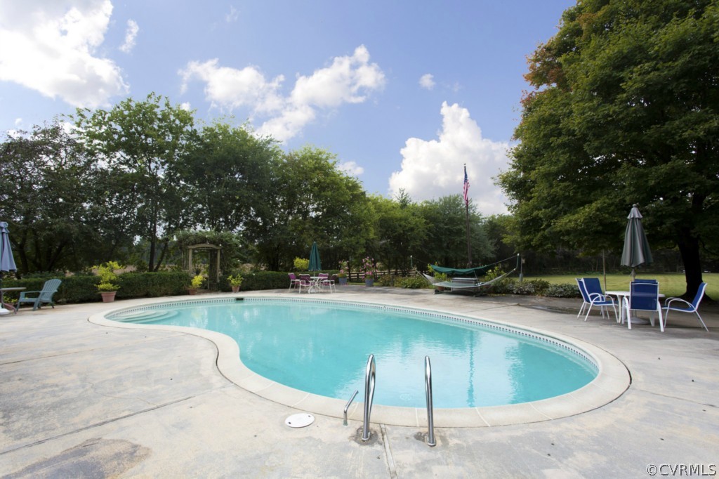 812 Shirley Plantation Road Charles City, VA 23030 - Photo 15 of 24 a swimming pool with outdoor seating and yard