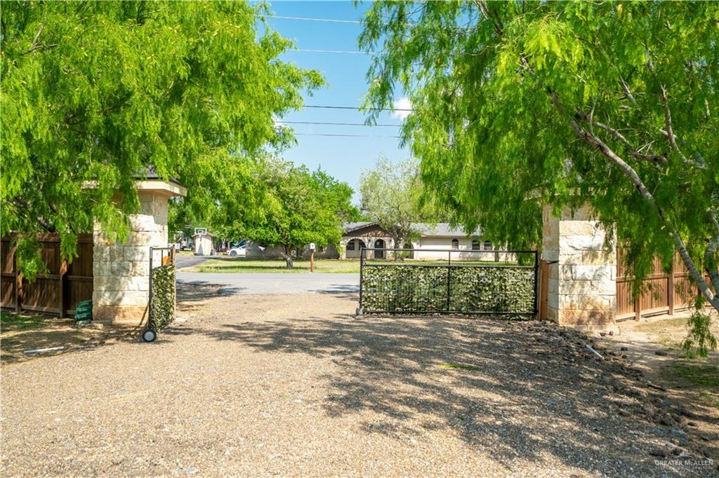 1627 South Midway Road Donna, TX 78537 - Photo 25 of 36 a view of a park that has large trees and a wooden fence