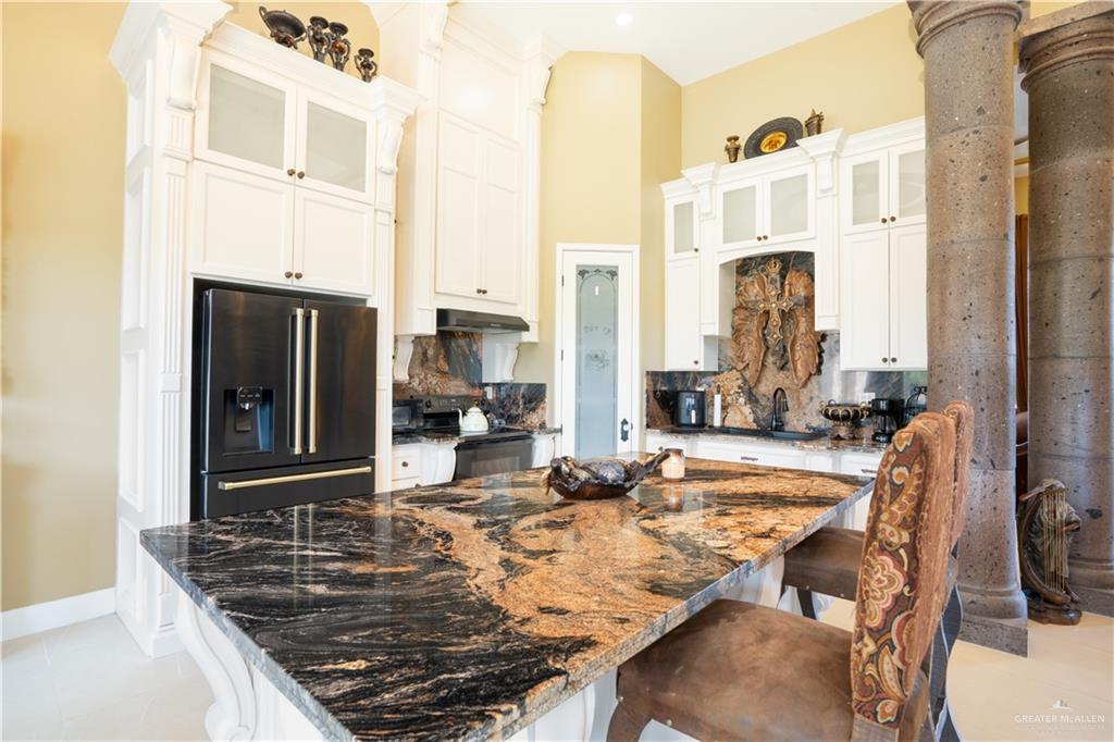 1627 South Midway Road Donna, TX 78537 - Photo 5 of 36 a view of a kitchen with granite countertop a sink and a refrigerator