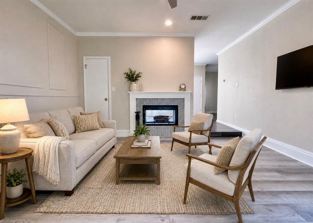 5616 Preston Oaks Road, Unit 1605 Dallas, TX 75254 - Photo 9 of 18 (Virtually Staged) The family room enjoys the double-sided fireplace as well as lots of natural light.