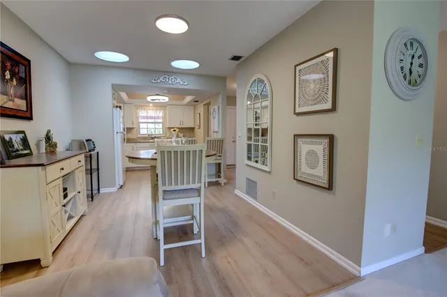 a large kitchen with a table and chairs