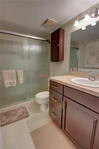 a bathroom with a sink toilet and shower