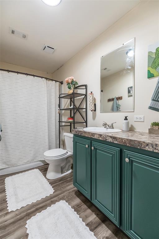 308 Marion Street Merkel, TX 79536 - Photo 12 of 20 a bathroom with a granite countertop sink toilet and mirror