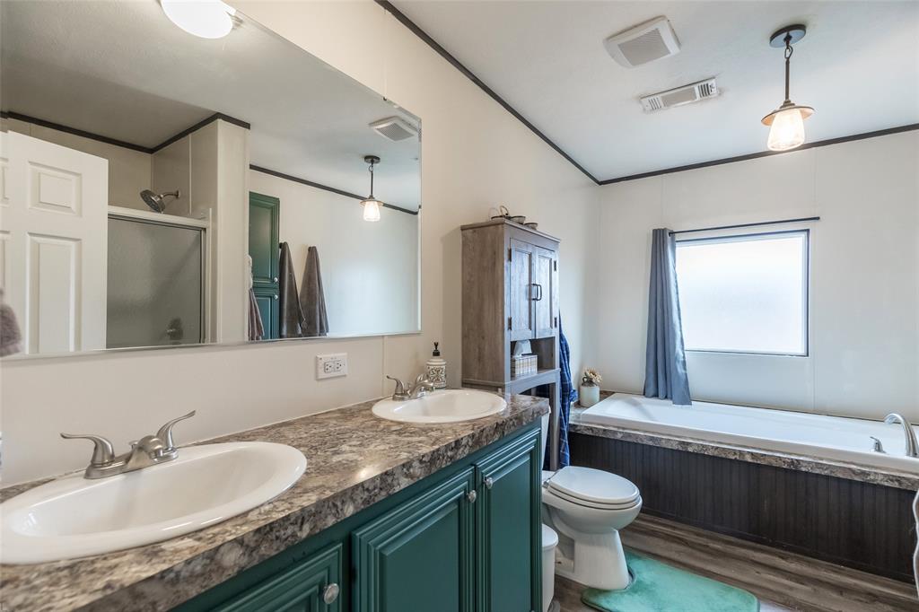 308 Marion Street Merkel, TX 79536 - Photo 15 of 20 a bathroom with a granite countertop sink toilet and mirror