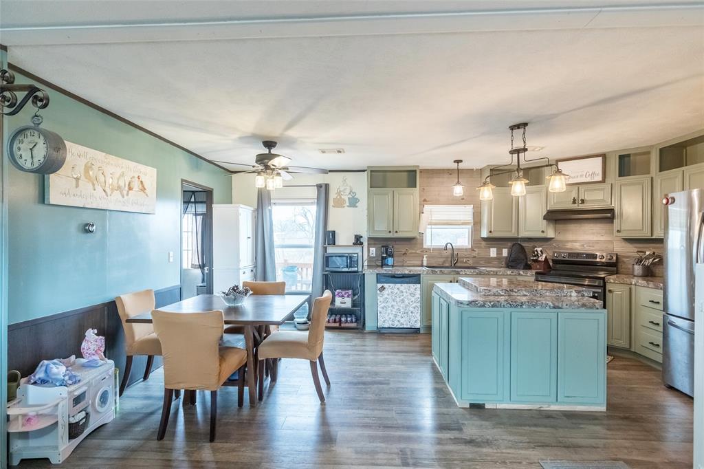 308 Marion Street Merkel, TX 79536 - Photo 4 of 20 a kitchen with a dining table chairs and refrigerator