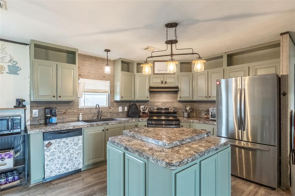 308 Marion Street Merkel, TX 79536 - Photo 5 of 20 a kitchen with stainless steel appliances granite countertop a sink stove and refrigerator