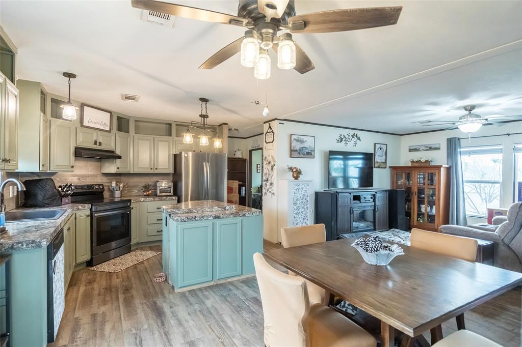 308 Marion Street Merkel, TX 79536 - Photo 6 of 20 a kitchen with kitchen island a sink stove and refrigerator with wooden floor
