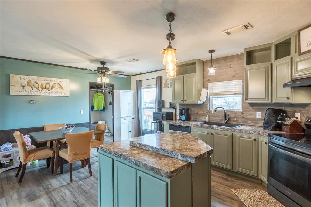 308 Marion Street Merkel, TX 79536 - Photo 7 of 20 a kitchen with center island and stainless steel appliances