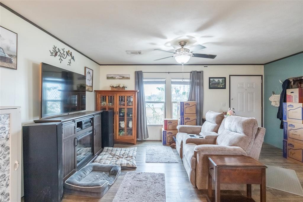 308 Marion Street Merkel, TX 79536 - Photo 8 of 20 a living room with furniture a flat screen tv and a fireplace