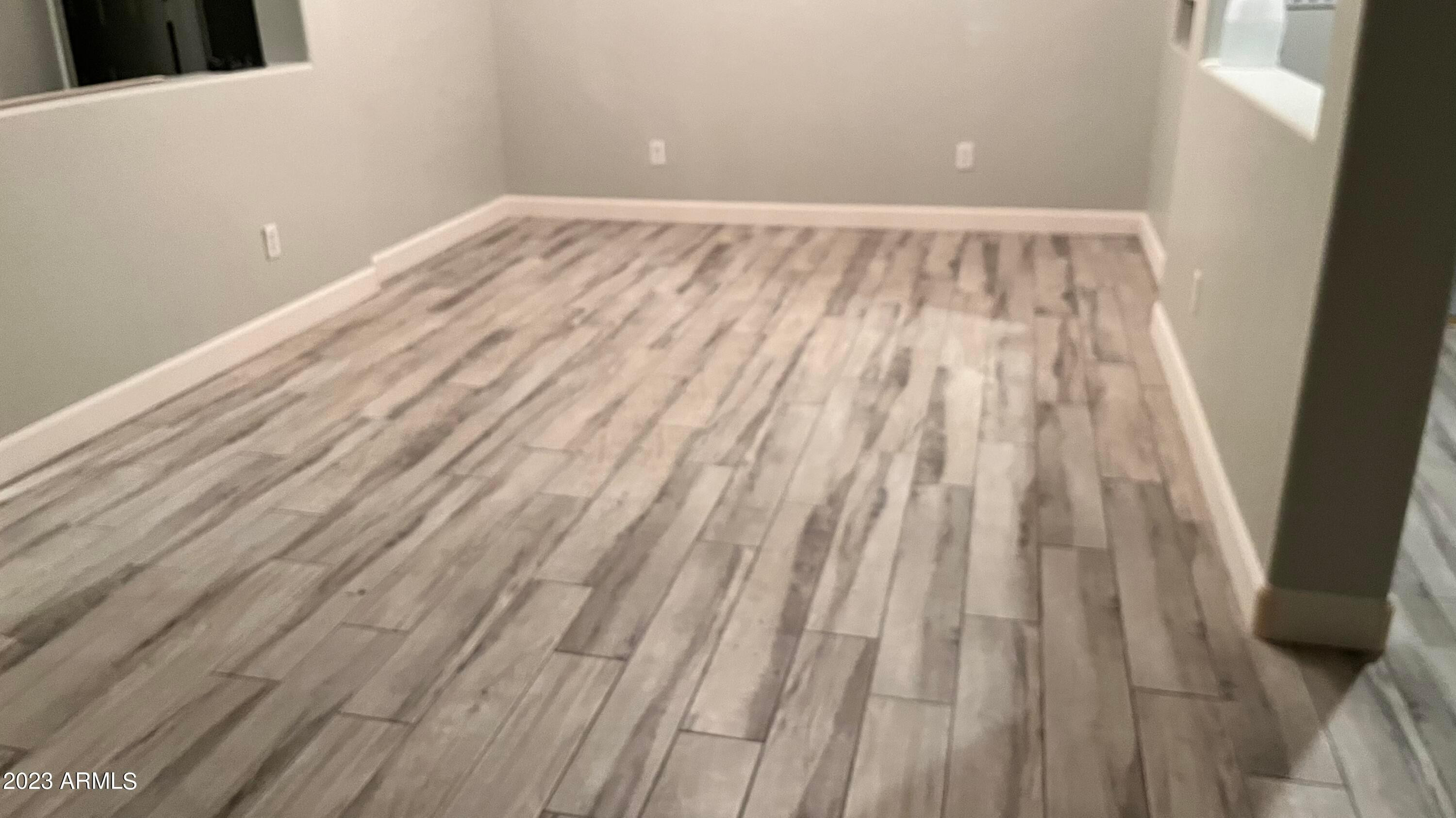 232 West Hawk Way Chandler, AZ 85286 - Photo 9 of 16 a view of an empty room with wooden floor